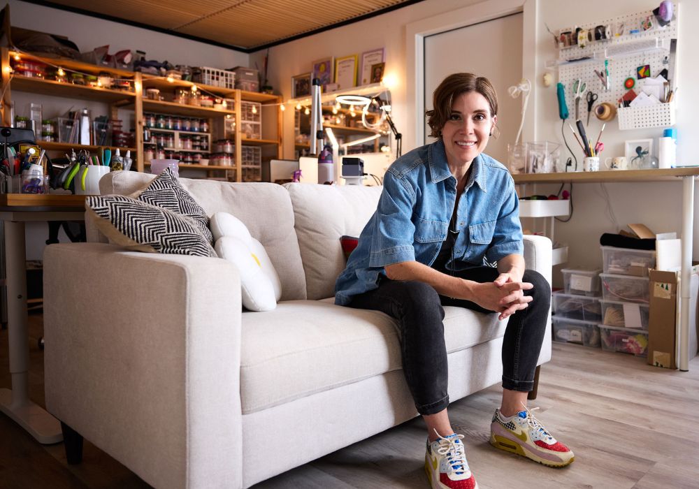 Katie Heiselberg in her Austin glass jewelry studio with organized supplies and workspace