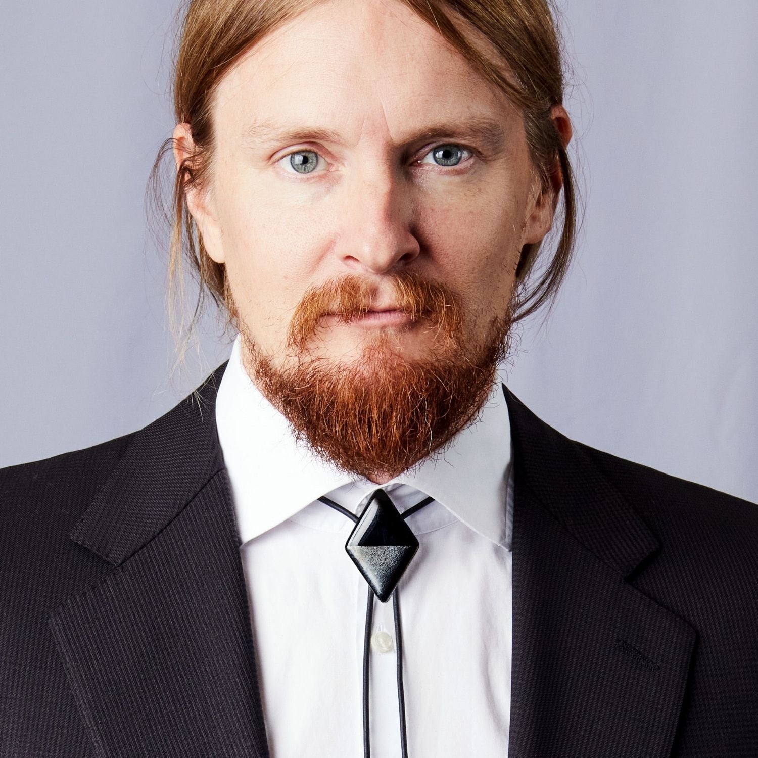 Man wearing black diamond bolo tie with formal suit professional styling