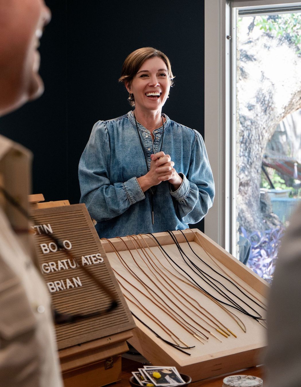 Katie Heiselberg hosting a Build Your Own Bolo event in her Austin Texas studio, with bolo cord options displayed on a wooden tray