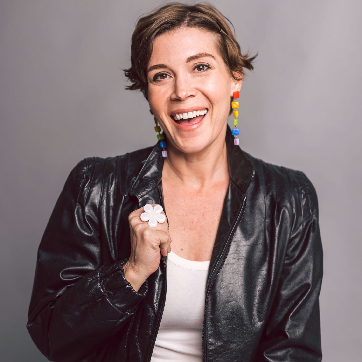 Katie Heiselberg wearing handmade rainbow glass geometric drop earrings