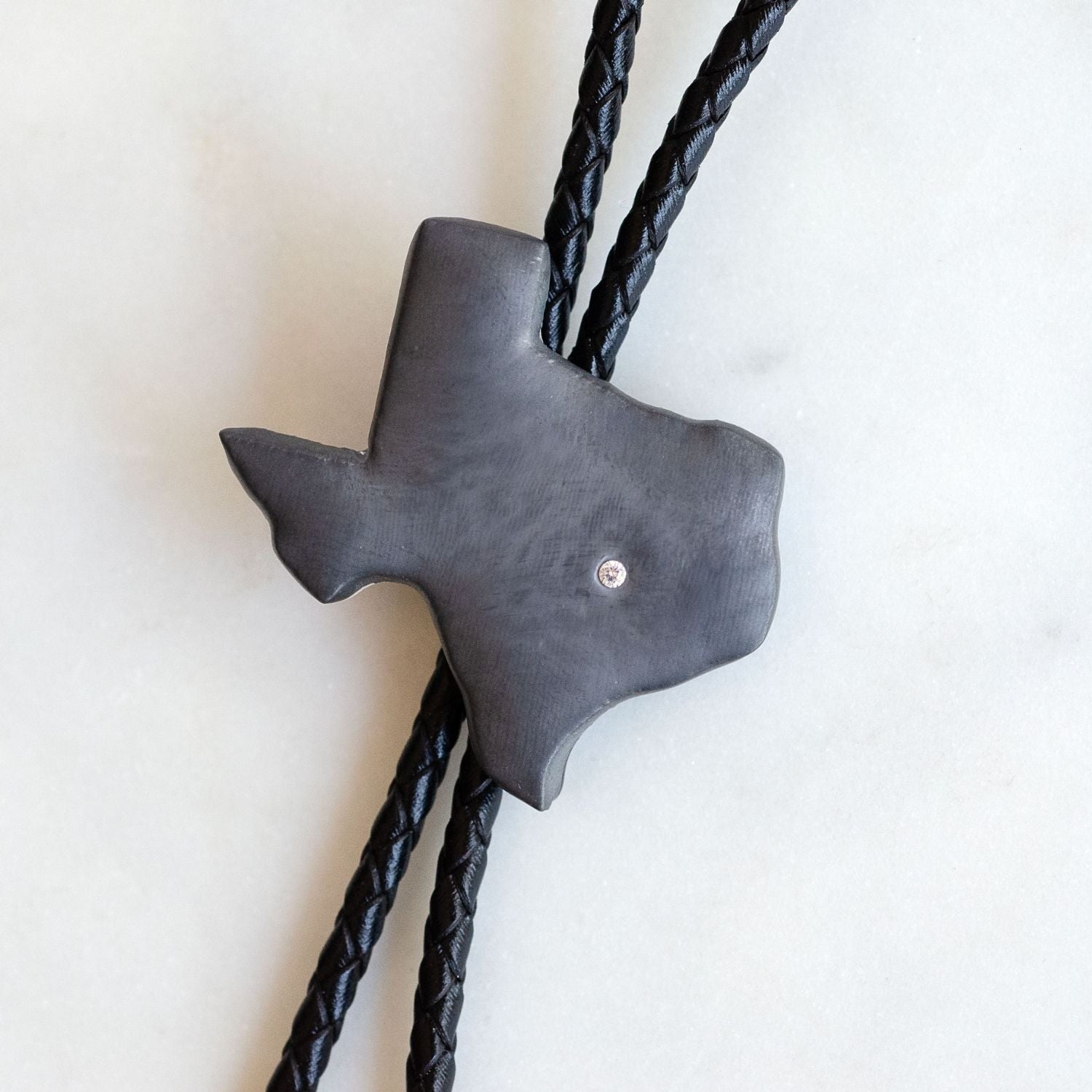 Black Texas shaped bolo tie with braided leather cord heritage design