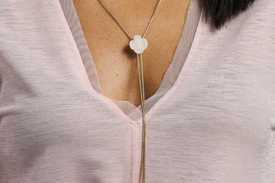 Woman wearing layered glass disc pendant necklace with minimalist styling