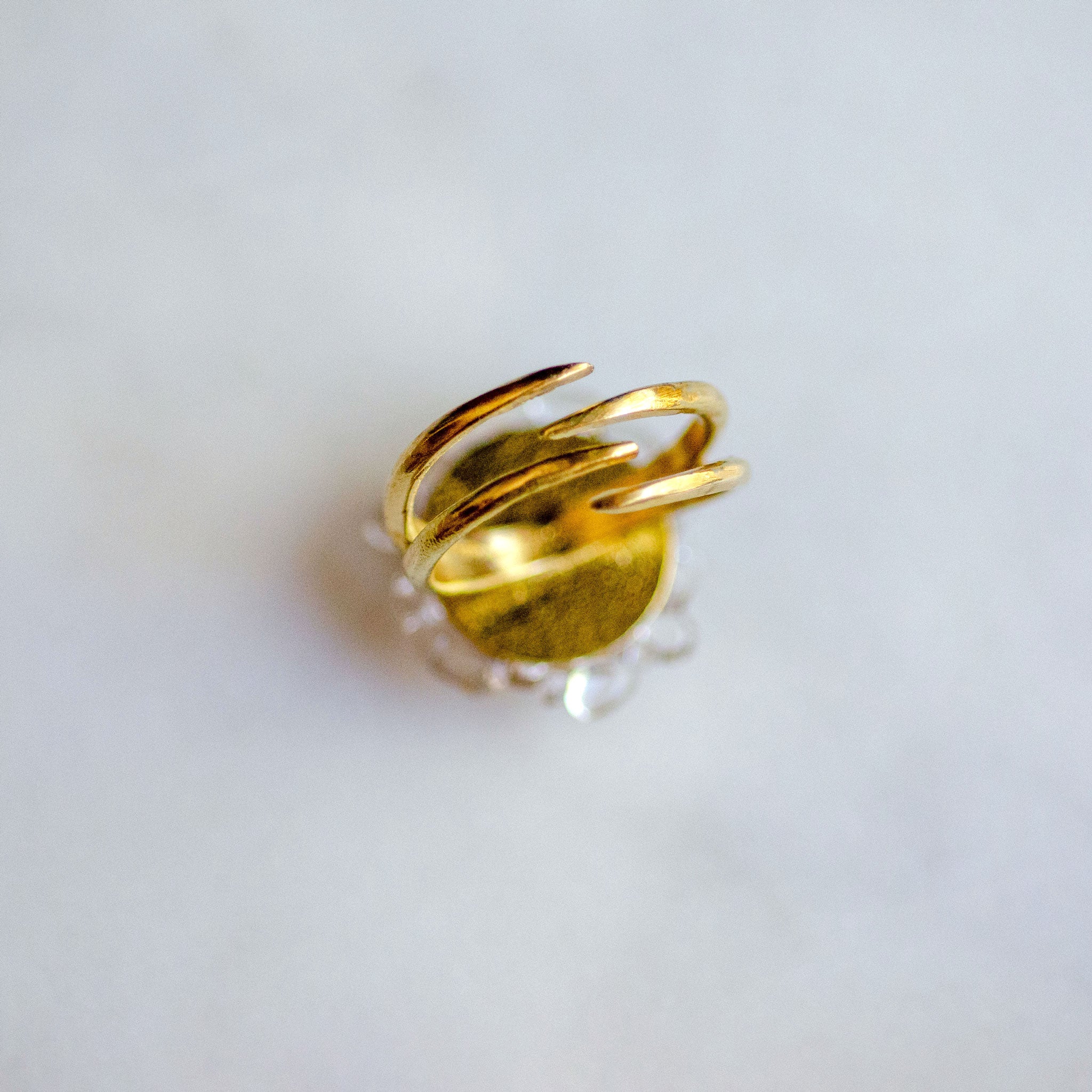 Band view of glass and brass adjustable ring with 22 karat gold luster