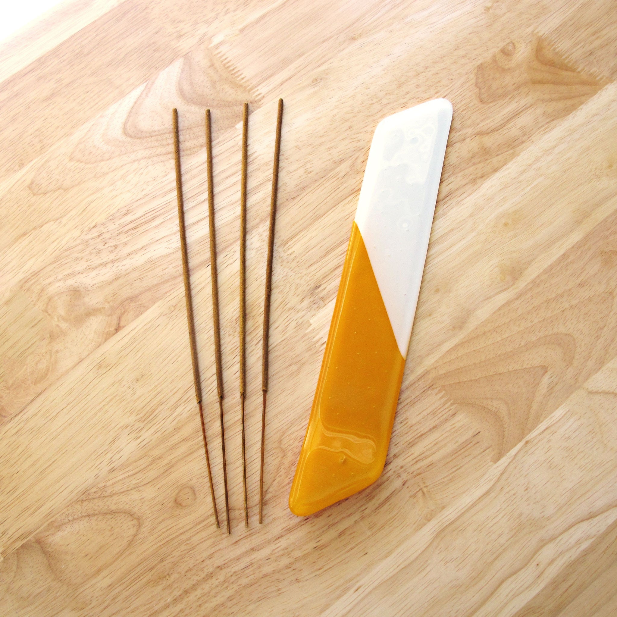Katie Kismet yellow and white incense burner with four sticks of incense (flat view)